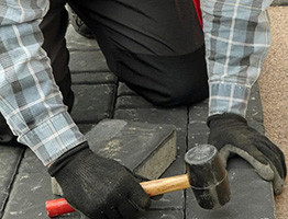 man laying driveway slabs