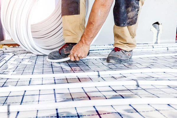 plumber laying underfloor heating