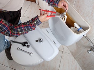 Plumber fitting toilet